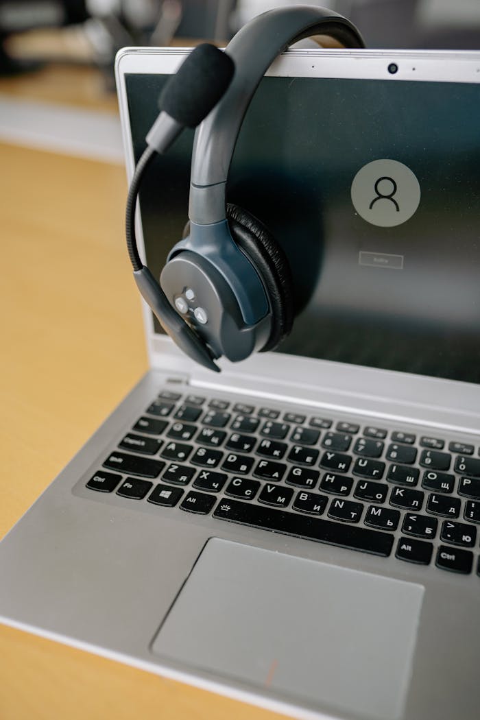 why-choose-us Close-up of a laptop with a headset, symbolizing online communication and remote work.